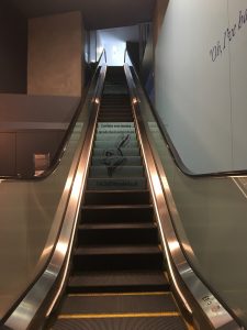 A photo of post-visit signage by the escalator.
