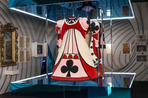 A photo of an Alice-type dress hanging from the ceiling.