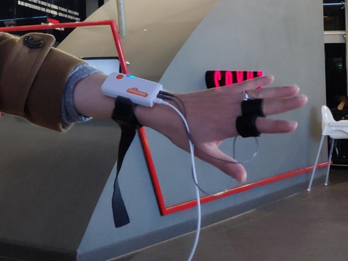 A person has wires connected to their hand.