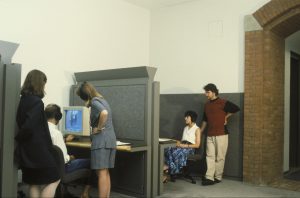 Visitors using computer terminals in a museum.