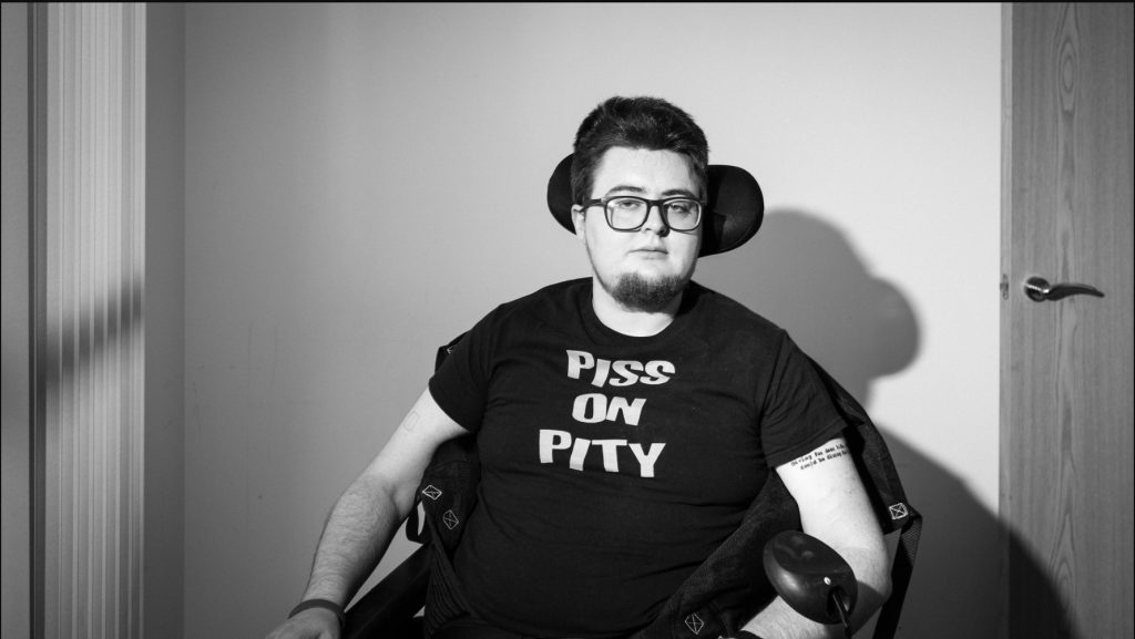 A black-and-white photo of a man in a wheelchair.