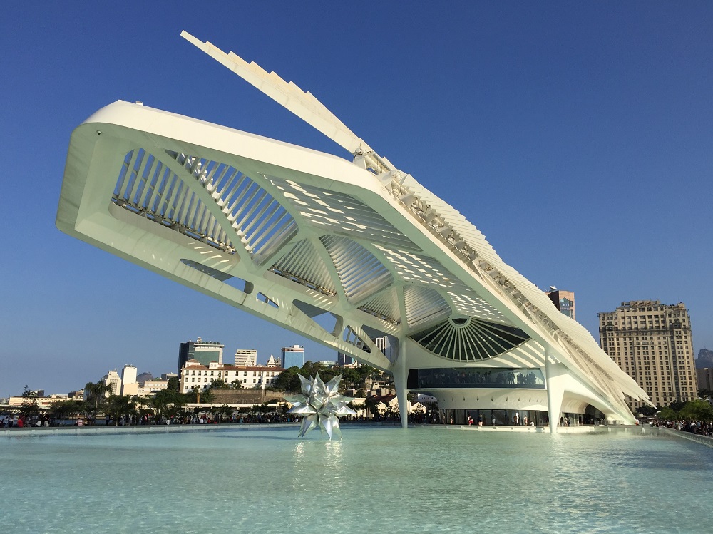 Later facade of the building of the Museum of Tomorrow, inspired by the bromeliad flower, that rises on a huge lake where is a metallic sculpture similar to a star.